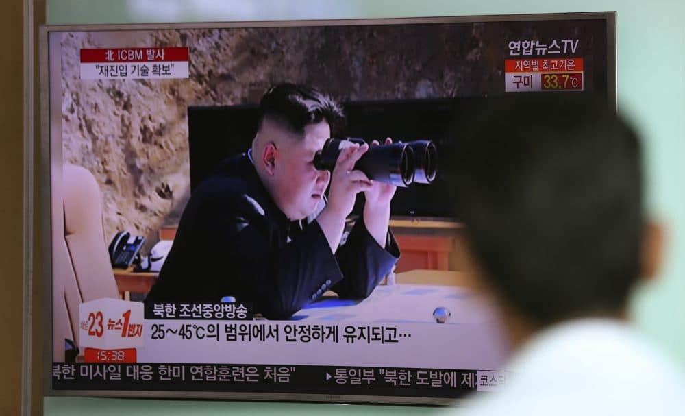 A man watches a TV screen showing a local news program reporting about North Korea's missile firing with an image of North Korean leader Kim Jong Un with a pair of binoculars, at Seoul Train Station in Seoul, South Korea, Wednesday, July 5, 2017. North Korea's leader Kim Jong Un vowed his nation would "demonstrate its mettle to the U.S." and never put its weapons programs up for negotiations a day after test-launching its first intercontinental ballistic missile. (Lee Jin-man/AP)