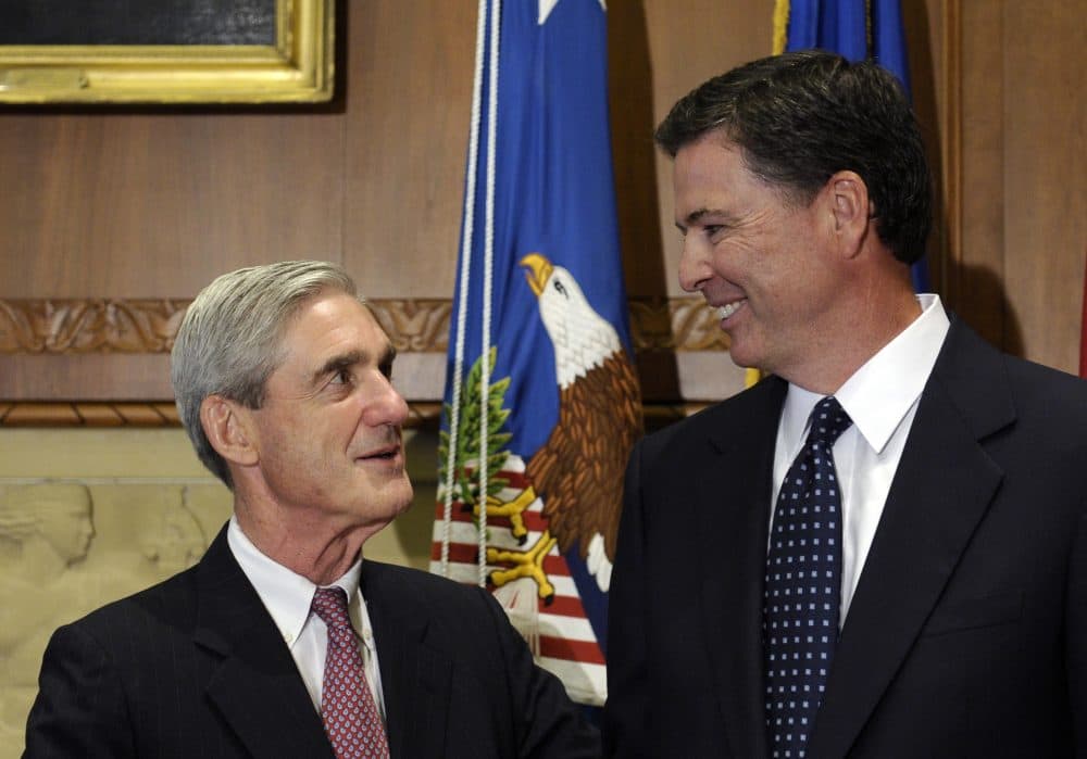 In this Sept. 4, 2013, file photo, then-incoming FBI Director James Comey talks with outgoing FBI Director Robert Mueller before Comey was officially sworn in at the Justice Department in Washington. (Susan Walsh/AP)