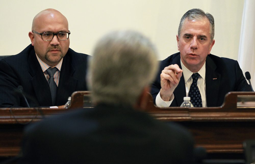 Massachusetts State Reps. Jeffrey Sanchez, D-Jamaica Plain, left, Harold Naughton, D-Clinton, right, take testimony from James DeVita, center, a member of the Mass. Board of Registration in Pharmacy, during a legislative hearing on the New England Compounding Center and tainted pharmaceuticals at the State House in Boston in 2012. (Steven Senne/AP)