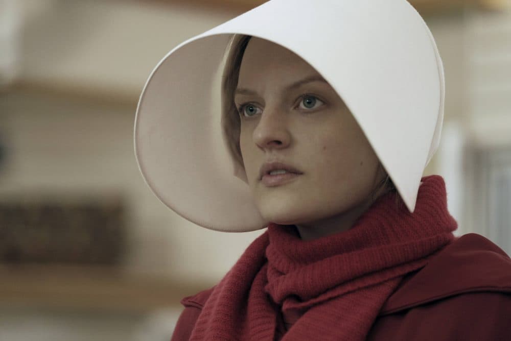 This image released by Hulu shows Elisabeth Moss as Offred in a scene from, "The Handmaid's Tale." Moss was nominated for an Emmy Award for outstanding lead actress in a drama series on Thursday, July 13, 2017. (George Kraychyk/Hulu via AP)