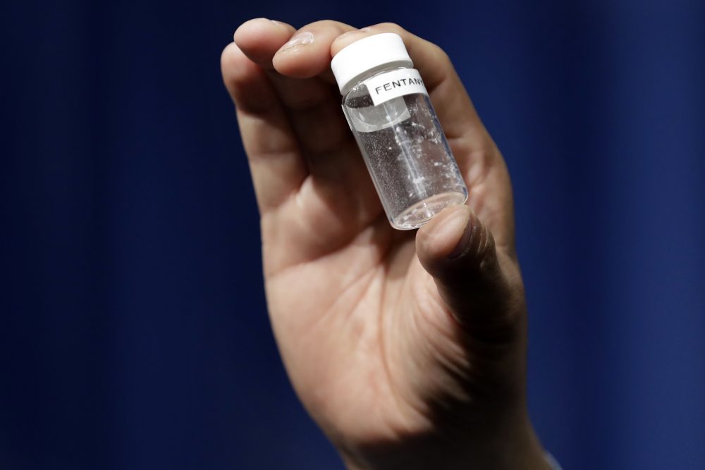 A reporter holds up an example of the amount of fentanyl that can be deadly, after a news conference about deaths from fentanyl exposure, at DEA headquarters in Arlington, Va. (Jacquelyn Martin/AP)
