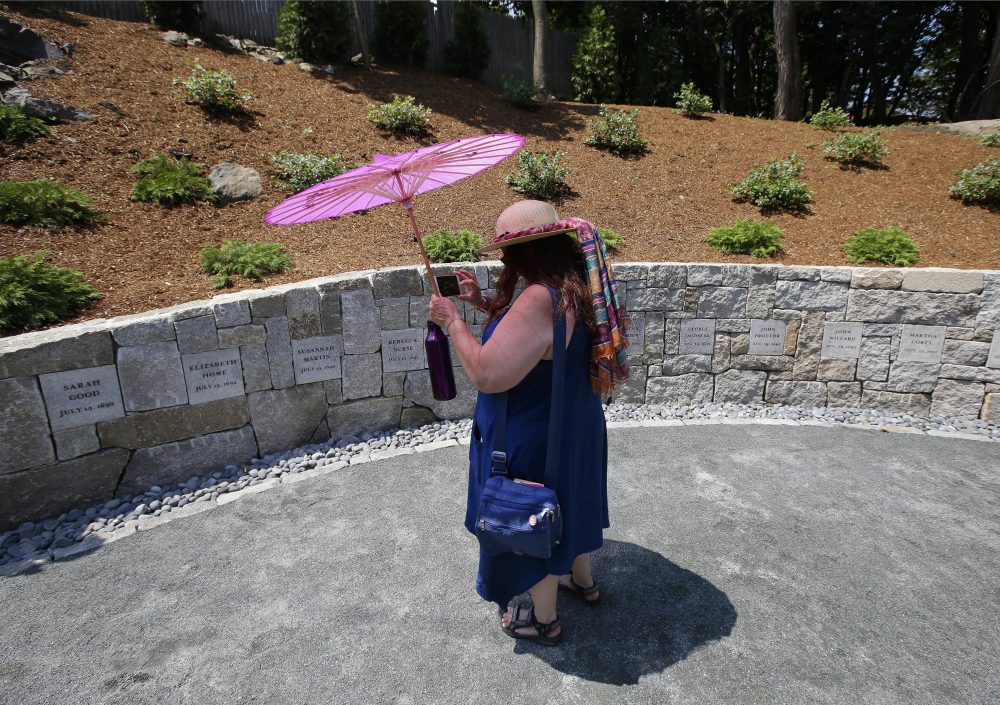 Karla Hailer, a fifth grade teacher from Situate, makes a video of the Proctor's Ledge memorial. (Stephan Savoia/AP)