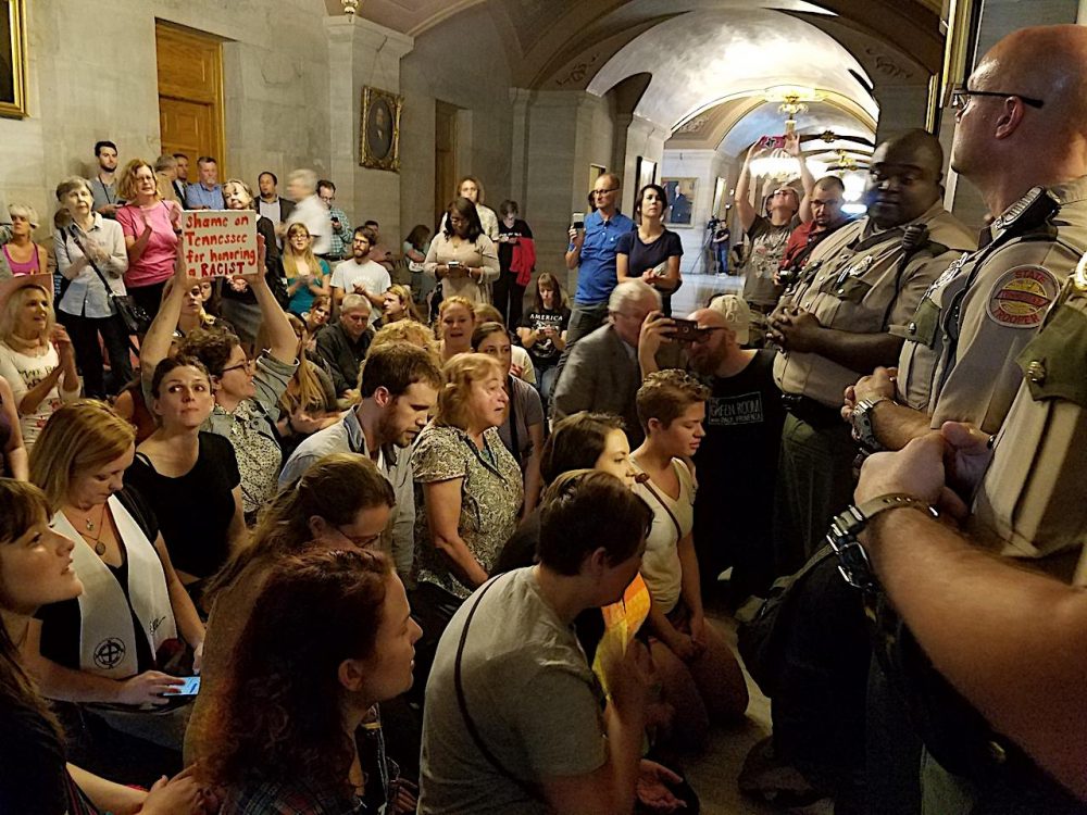 Protesters kneel outside the office of Gov. Bill Haslam Monday to call for the removal of a bust of Nathan Bedford Forrest. (Chas Sisk/WPLN)