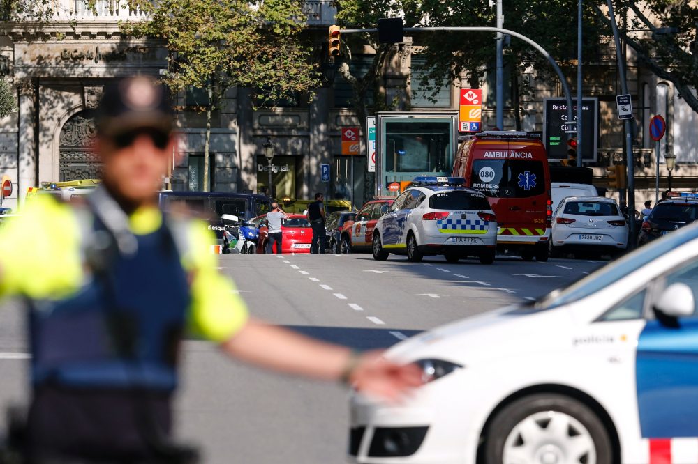 A policeman stand as he blocks the street to a cordoned-off area after a van plowed into a crowd, injuring several persons on the Rambla in Barcelona on Aug. 17, 2017. (Pau Barrena/AFP/Getty Images)