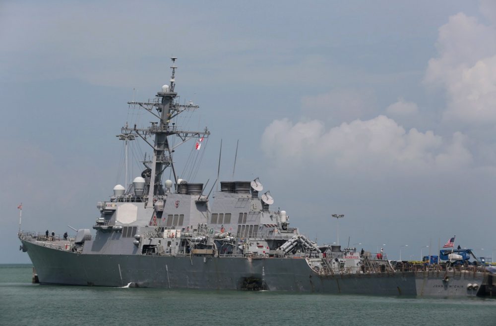 The guided-missile destroyer USS John S. McCain (DDG 56) is moored pier side at Changi naval base in Singapore following a collision with the merchant vessel Alnic MC Monday, Aug. 21, 2017. The USS John S. McCain was docked at Singapore's naval base with "significant damage" to its hull after an early morning collision with the Alnic MC as vessels from several nations searched Monday for missing U.S. sailors. (Grady T. Fontana/U.S. Navy photo via AP)