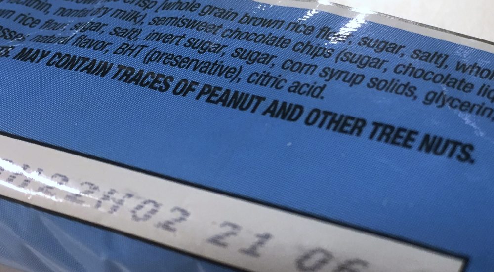 This Nov. 30, 2016, photo shows part of a food label that states the product "may contain traces of peanut and other tree nuts" as photographed in Washington. (Jon Elswick/AP)