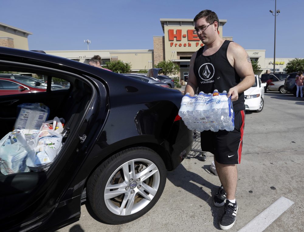 William Hazzard loads water into his car in preparation for tropical weather on Thursday, Aug. 24, 2017, in Houston. Tropical Storm Harvey is expected to intensify over the warm waters of the Gulf of Mexico before reaching the Texas coast Friday. (David J. Phillip/AP)