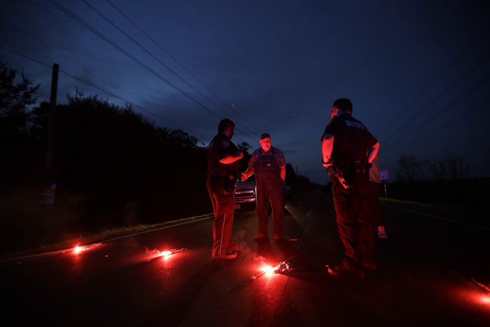 A man talks with officers at a roadblock less than three miles from the Arkema Inc. chemical plant Thursday, Aug. 31, 2017, in Crosby, Texas. The Houston-area chemical plant that lost power after Harvey engulfed the area in extensive floods was rocked by multiple explosions early Thursday, the plant's operator said. (Gregory Bull/AP)