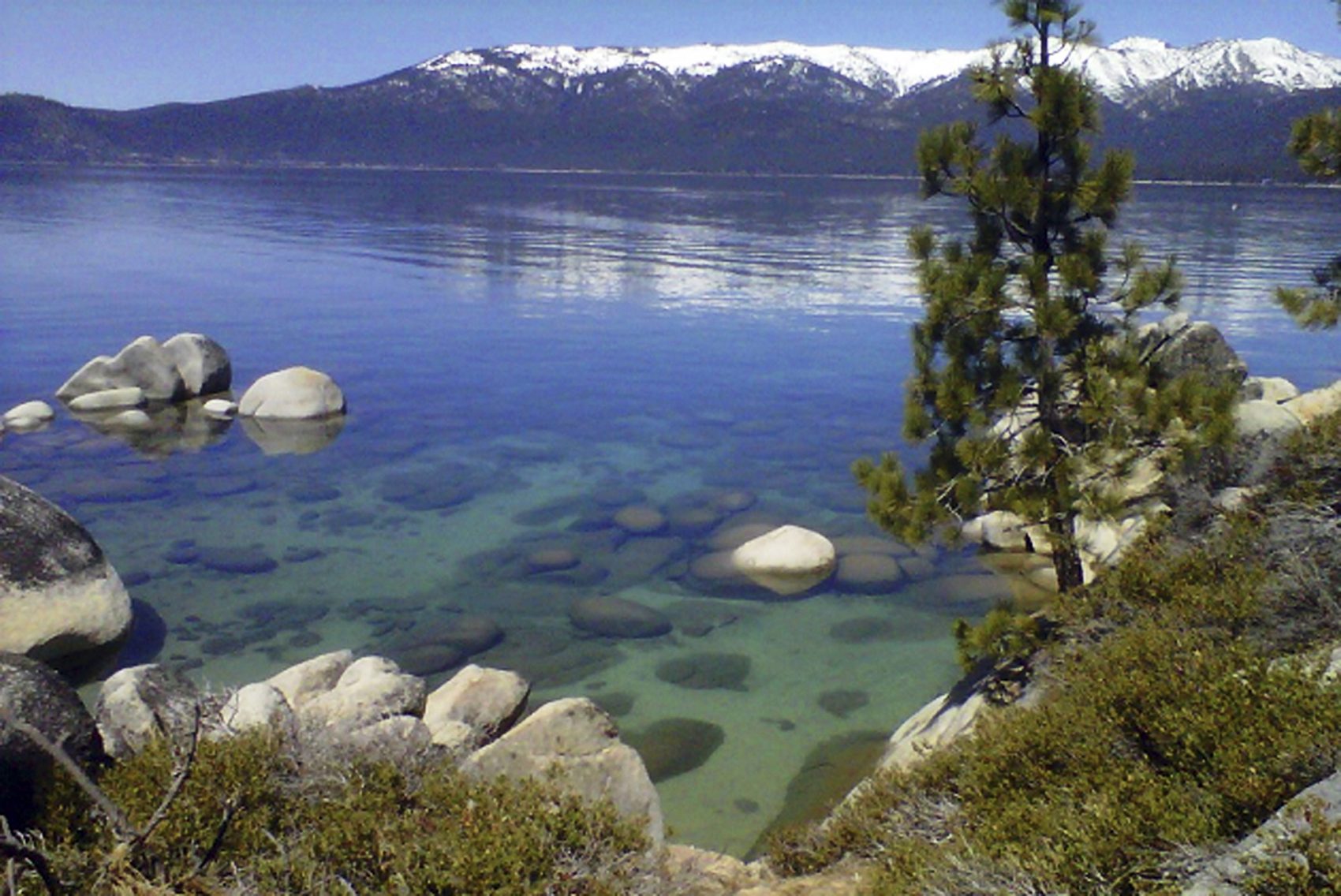 This April 12, 2012 file photo shows Lake Tahoe seen from Incline Village, Nev. An annual report on Lake Tahoe said the United States' largest alpine lake is still warming at 14 times the historic average. (AP Photo/Scott Sonner, File)