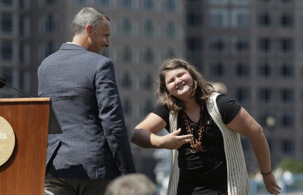 Jane Richard bows toward the audience after making remarks as her father Bill Richard, left, looks on during groundbreaking ceremonies for a park named after Martin Richard. (Steven Senne/AP)