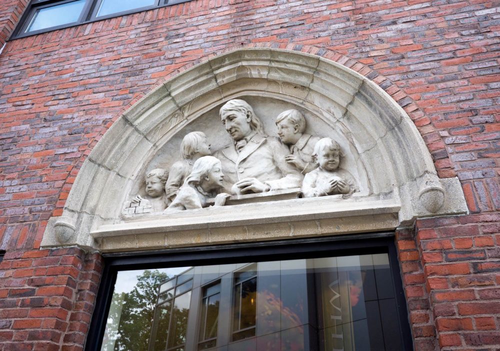 A frieze above the doorway to Wheelock College's library, showing Friedrich Fröbel, founder of the kindergarten movement. (Max Larkin/WBUR)