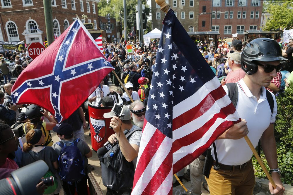 White nationalist demonstrators walk into Lee park surrounded by counter demonstrators in Charlottesville, Va., Saturday, Aug. 12, 2017. Gov. (Steve Helber/AP)