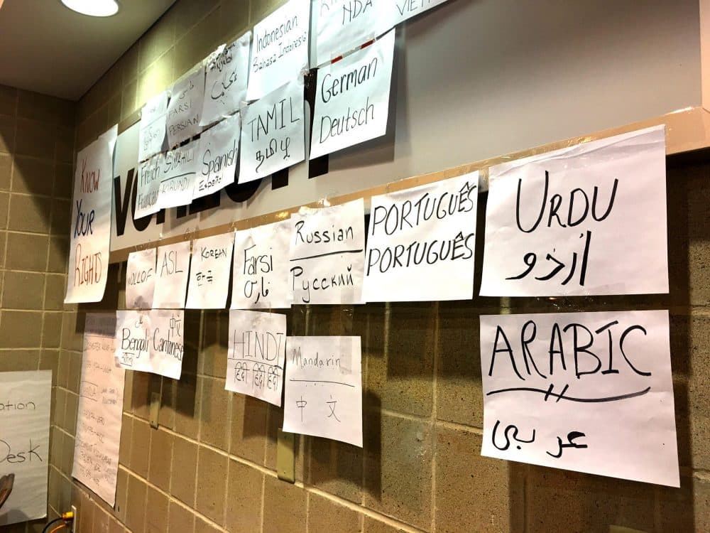 Houston Immigration Legal Services Collaborative is set up at the NRG Center, with several posters that hope to welcome undocumented immigrants and encourage them to get help. (Stella M. Chavez/KERA News)