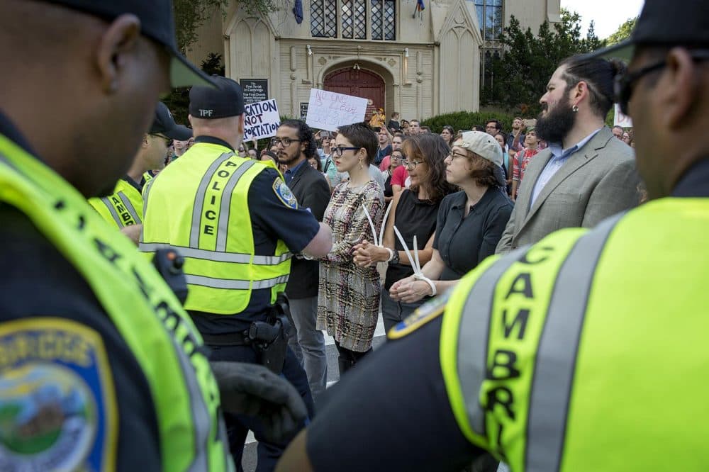 More than two dozen people were arrested in Harvard Square Thursday as they protested the Trump administration's plans to end the DACA program. The protest was organized by a group of professors from local colleges and billed as "an act of non-violent civil disobedience." (Robin Lubbock/WBUR)