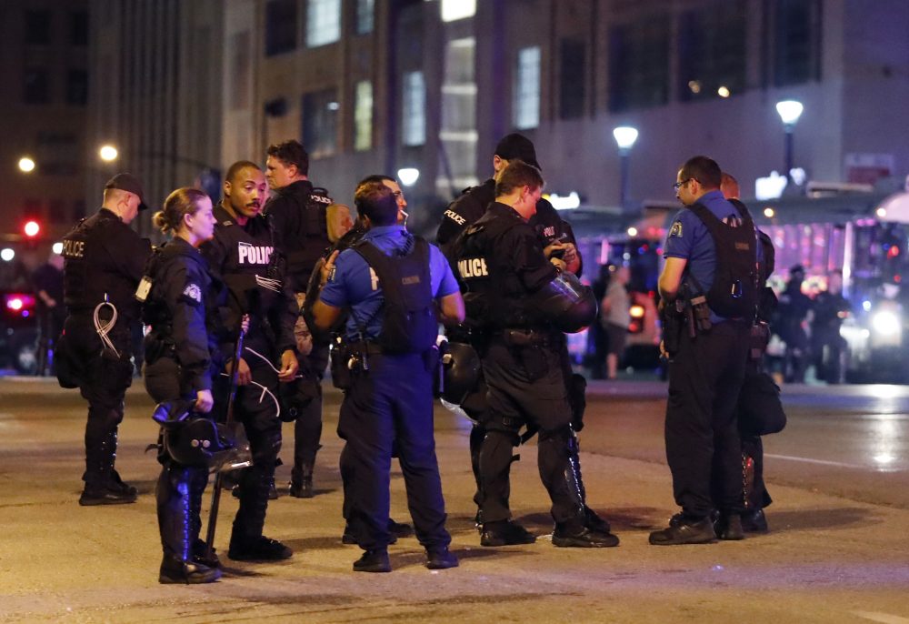 Police talk after multiple arrests were made following a protest in response to a not guilty verdict in the trial of former St. Louis police officer Jason Stockley Monday, Sept. 18, 2017, in St. Louis. Stockley was acquitted on Friday in the 2011 killing of a black man following a high-speed chase. (Jeff Roberson/AP)