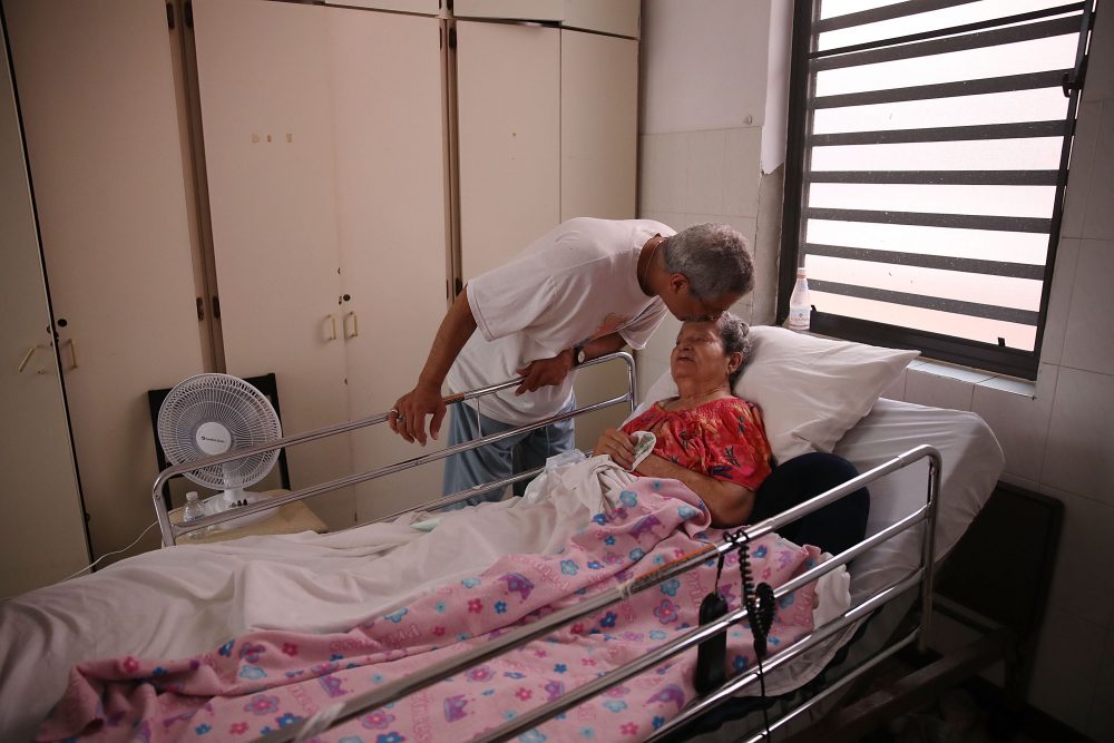Rafael Robles-Ortiz kisses his mother Josefina Ortiz, who is staying at the Hermanitas de los Ancianos Desamparados facility, which cares for the elderly, as they deal with the aftermath of Hurricane Maria, on Sept. 26, 2017 in San Juan, Puerto Rico. (Joe Raedle/Getty Images)