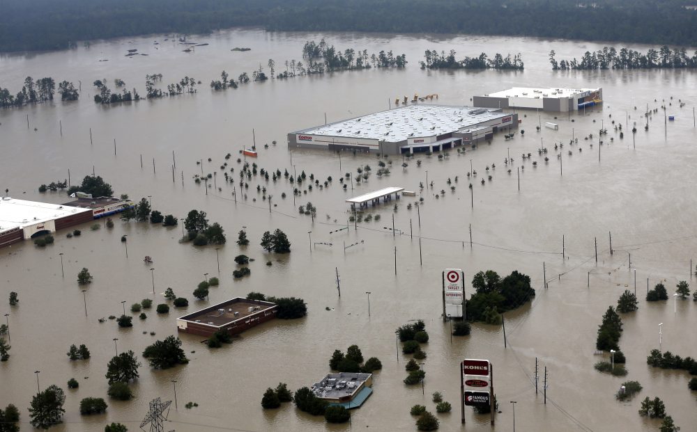 In this Tuesday, Aug. 29, 2017, file photo, businesses are surrounded by floodwaters from Harvey, in Humble, Texas. (David J. Phillip/AP)