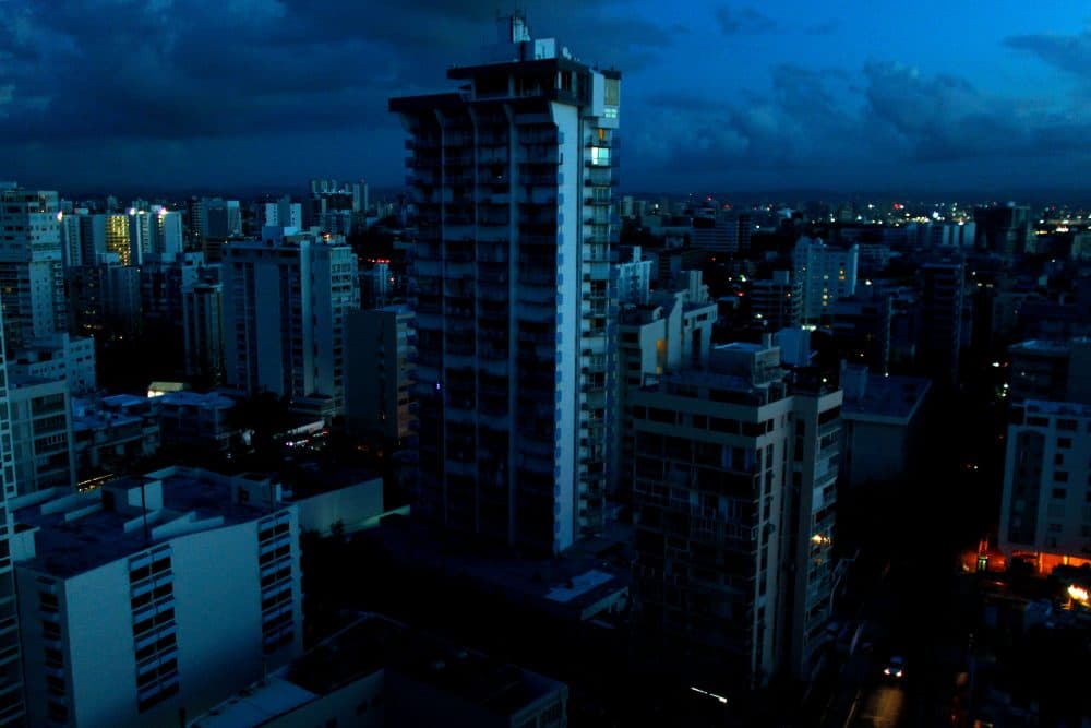 Blacked out buildings are seen in a tourist zone with lights only showing in buildings that have generators in San Juan, Puerto Rico, on Oct. 4, 2017. (Ricardo Arduengo/AFP/Getty Images)