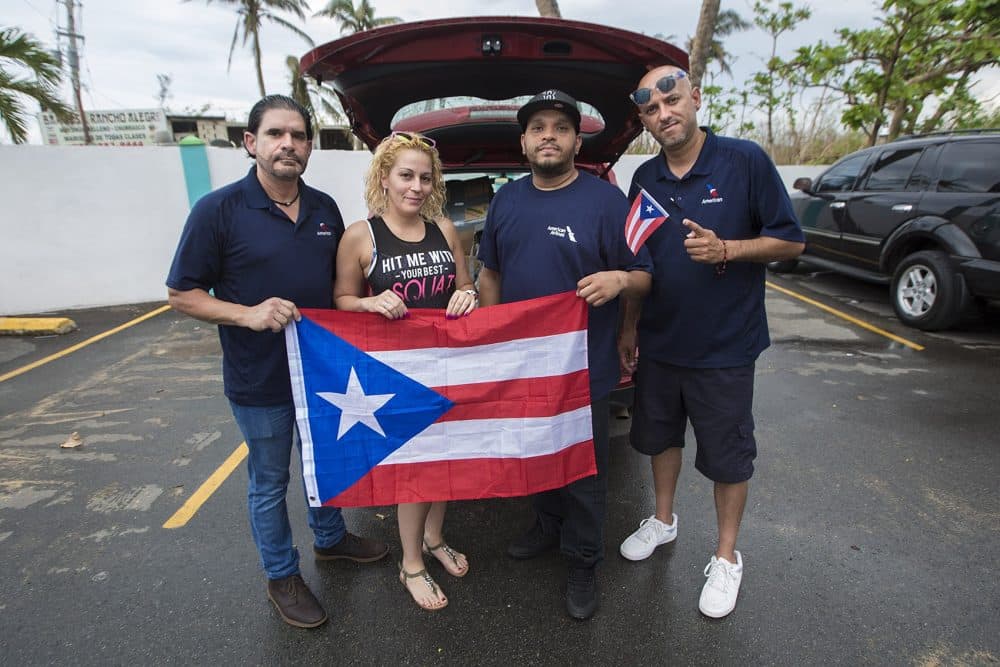 Richard Toledo of Revere, Dericka Avecedo of Danvers, Arnoldo Ortiz of Everett, and Humberto Rivera of Worcester are delivering supplies donated from the Boston area to cities and towns around Puerto Rico. (Jesse Costa/WBUR)