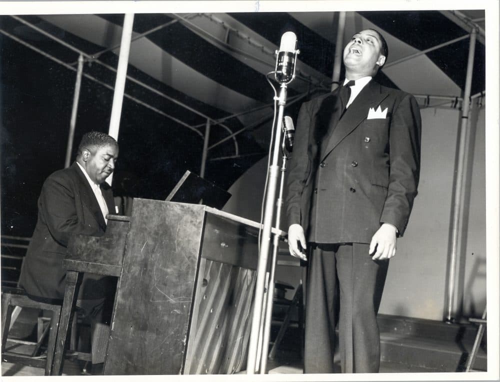 Pete Johnson playing piano and Big Joe Turner singing into a microphone onstage at Café Society in New York City. (Courtesy of the University of Missouri-Kansas City Libraries, Dr. Kenneth J. LaBudde Department of Special Collections)