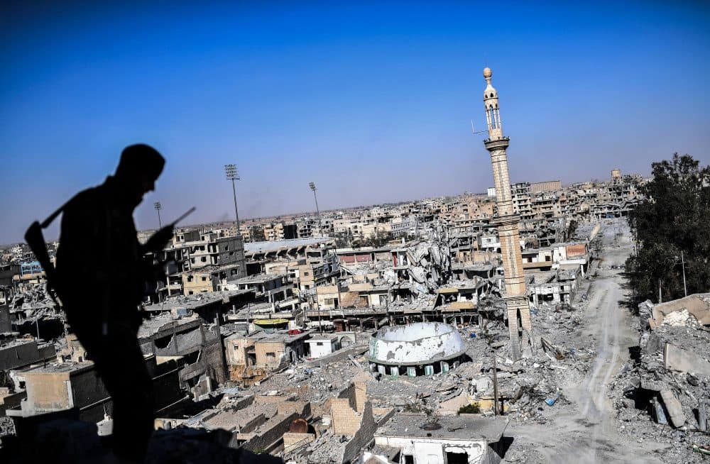 A member of the Syrian Democratic Forces (SDF), backed by U.S. special forces, talks on the radio near Raqqa's stadium as they clear the last positions on the frontline on Oct. 16, 2017, in the Islamic State group jihadists' crumbling stronghold. (Bulent Kilic/AFP/Getty Images)
