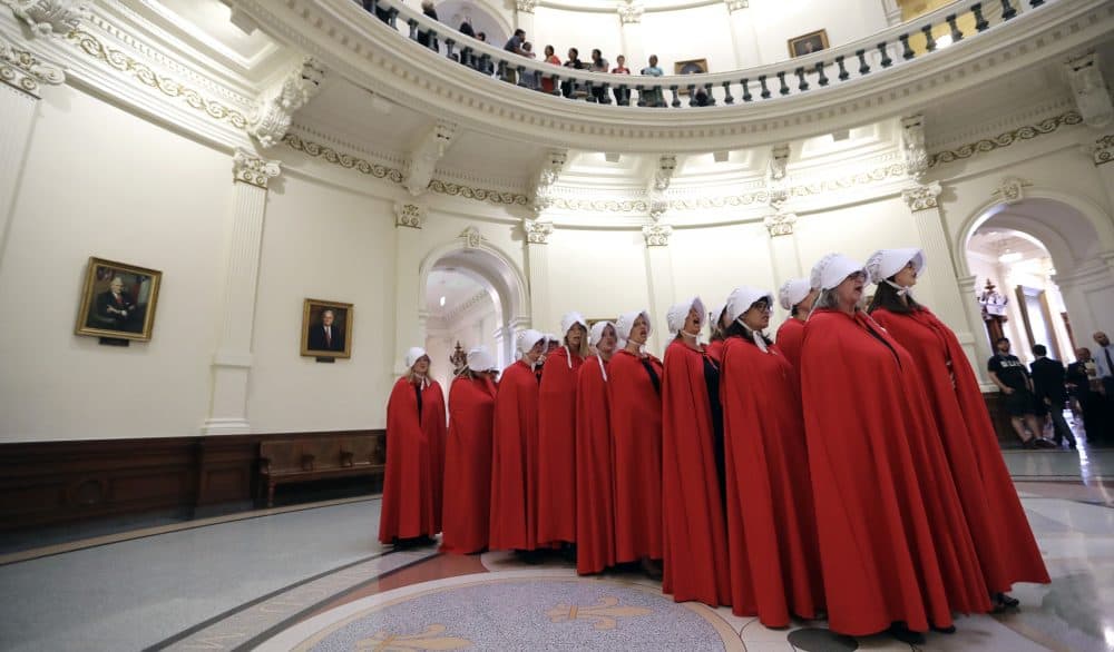 Activists dressed as characters from "The Handmaid's Tale" chant in the Texas Capitol Rotunda as they protest SB8, a bill that would require health care facilities, including hospitals and abortion clinics, to bury or cremate any fetal remains whether from abortion, miscarriage or stillbirth, and they would be banned from donating aborted fetal tissue to medical researchers, Tuesday, May 23, 2017, in Austin. (Eric Gay/AP)