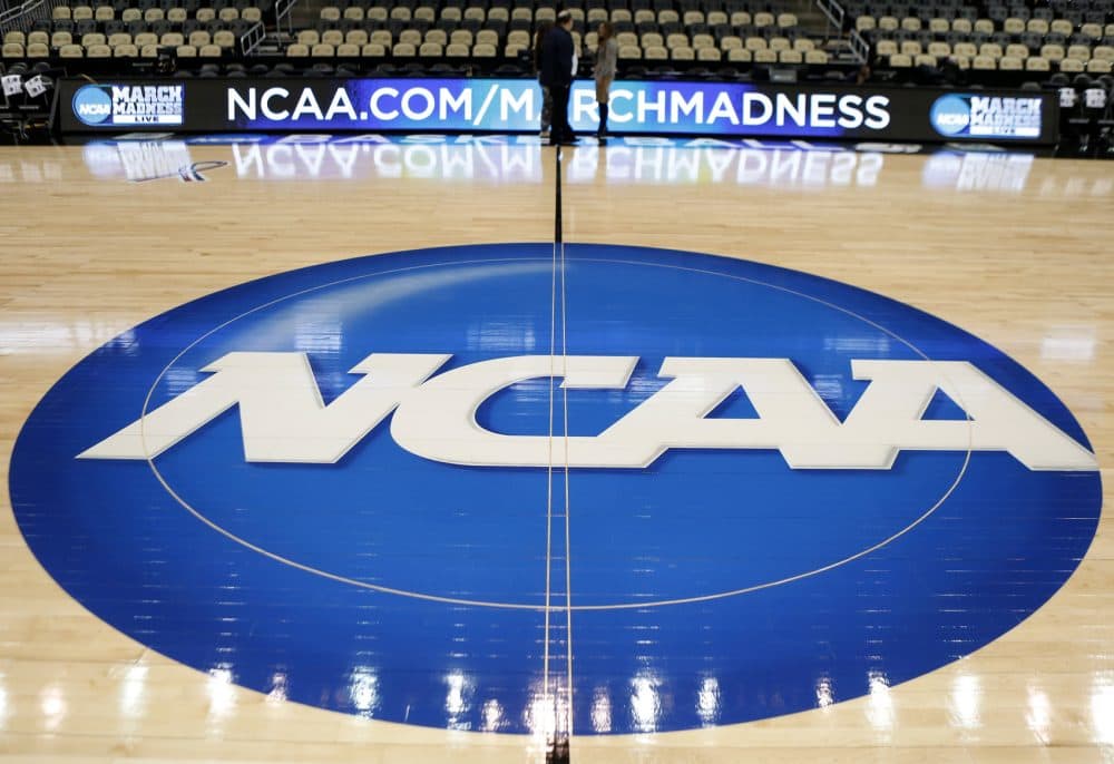 In this March 18, 2015 photo, the NCAA logo is at center court for the NCAA college basketball second and third round games. The NCAA and 11 major athletic conferences announced Friday, Feb. 3, 2017, they have agreed to pay $208.7 million to settle a federal class-action lawsuit filed by former college athletes who claimed the value of their scholarships was illegally capped.
(AP Photo/Keith Srakocic, File)