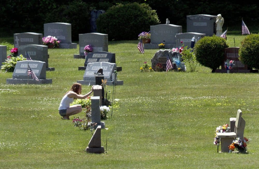 In this June 17, 2016 file photo, Erika Marble visits the gravesite of Edward Martin III, her fiancé and father of her two children, in Littleton, N.H. The 28-year old died Nov. 30, 2014, from an overdose of the opioid fentanyl. (Jim Cole/AP)