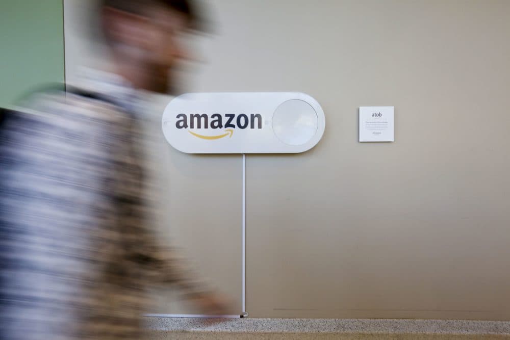 A student at the University of Alabama at Birmingham's Hill Student Center walks by a large Amazon Dash button, Monday, Oct. 16, 2017, in Birmingham, Ala. (Brynn Anderson/AP)