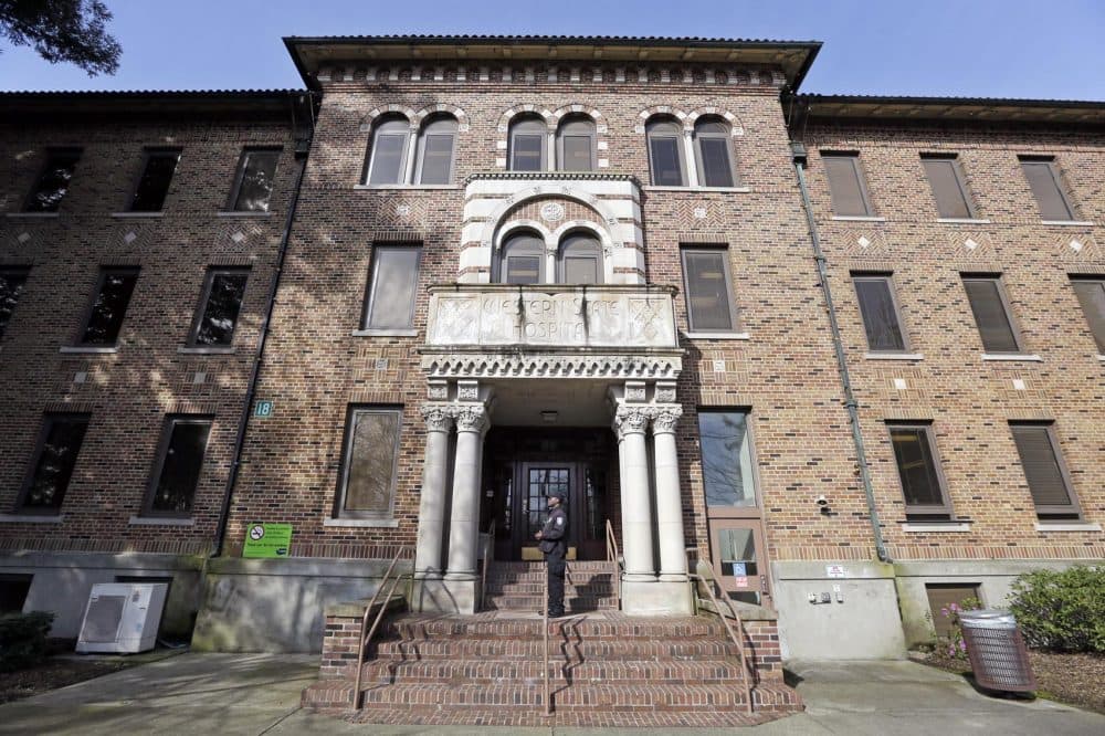 In this file photo taken April 11, 2017, a security officer stands on steps at the entrance to Western State Hospital, in Lakewood, Wash. (Elaine Thompson/AP)