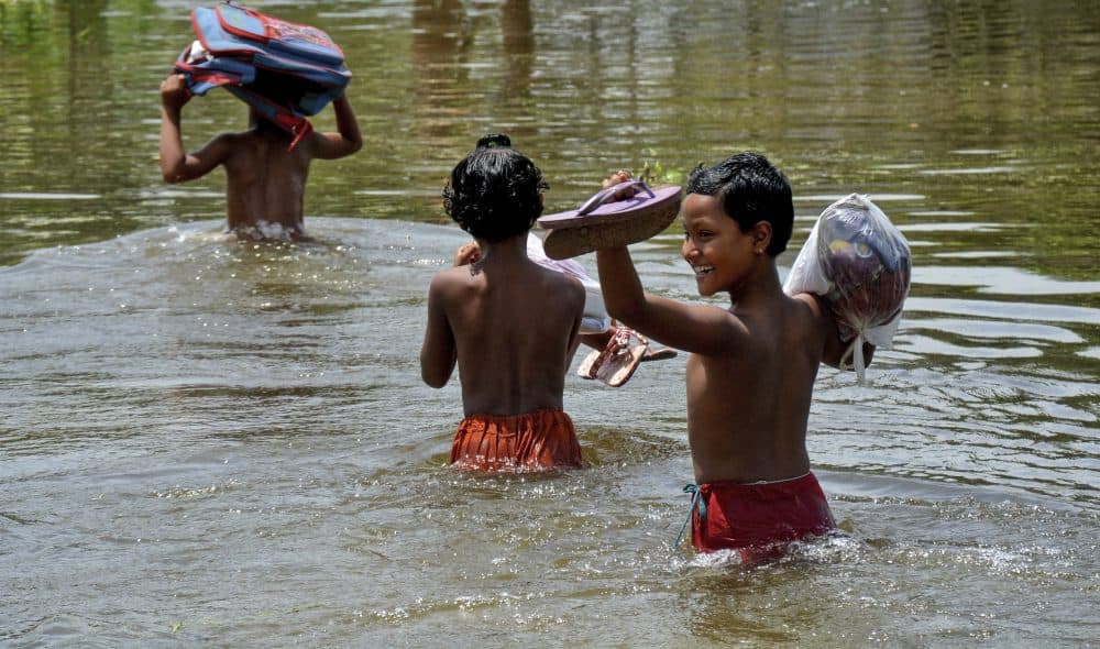 In this Saturday, Aug. 19, 2017 photo, schoolchildren wade past floodwaters in Gaibandha district, about 120 miles north of capital Dhaka, Bangladesh. Experts say local officials are ignoring dangers and pursuing development plans that only increase the risk of flood-related death and destruction as annual monsoon rains challenge cities to cope. (AP)