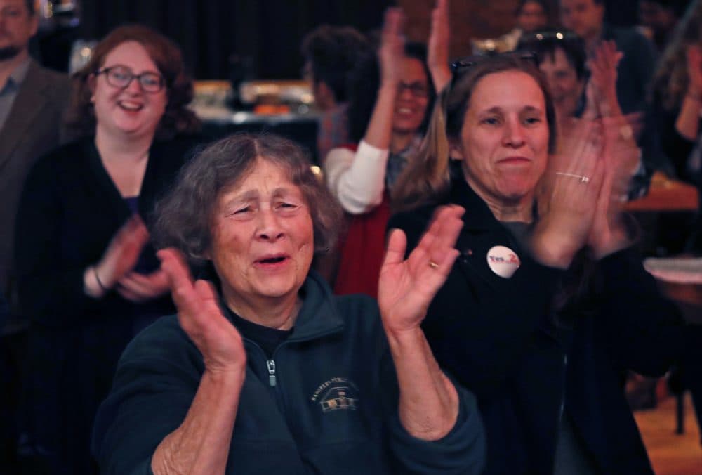 Chris Hastedt, left, and Robyn Merrill cheer during an announcement while awaiting results at the Mainers for Health Care election night party, Tuesday in Portland, Maine. (Robert F. Bukaty/AP)