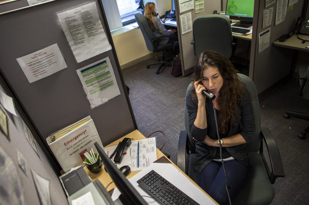Volunteer Emma speaks with a caller on the Samaritans hotline in its in-person days. (Jesse Costa/WBUR)