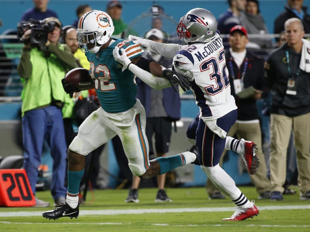 New England Patriots free safety Devin McCourty (32) attempts to stop Miami Dolphins running back Kenyan Drake (32), during the second half of an NFL football game, Monday, Dec. 11, 2017, in Miami Gardens, Fla. Drake had 114 yards rushing and 79 receiving during the game.(Wilfredo Lee/AP)