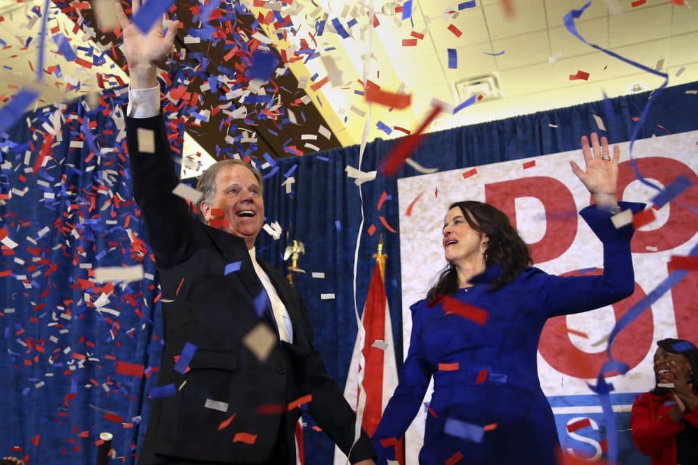 Democratic candidate for U.S. Senate Doug Jones and his wife Louise wave to supporters before speaking Tuesday, Dec. 12, 2017, in Birmingham, Ala. Jones has defeated Republican Roy Moore, a one-time GOP pariah who was embraced by the Republican Party and the president even after facing allegations of sexual impropriety. (AP Photo/John Bazemore)