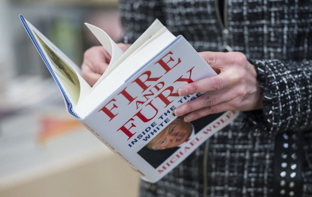 A man holds a copy of the book "Fire and Fury: Inside the Trump White House" by Michael Wolff, after buying it at a bookstore in Washington, D.C. on Jan. 5, 2018. The book was rushed into bookstores and onto e-book platforms four days ahead of schedule due to what its publisher called "unprecedented demand" — and after Trump's bid to block it failed. (Andrew Caballero-Reynolds/AFP/Getty Images)