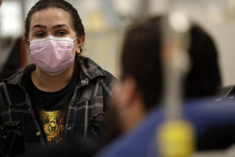 In this Jan. 10, 2018 photo, Torrey Jewett looks on as her roommate Donnie Cardenas recovers from the flu at the Palomar Medical Center in Escondido, Calif. Cardenas, a San Diego County resident, said he was battling a heavy cough for days before a spike his temperature sent him into the emergency room. (Gregory Bull/AP)