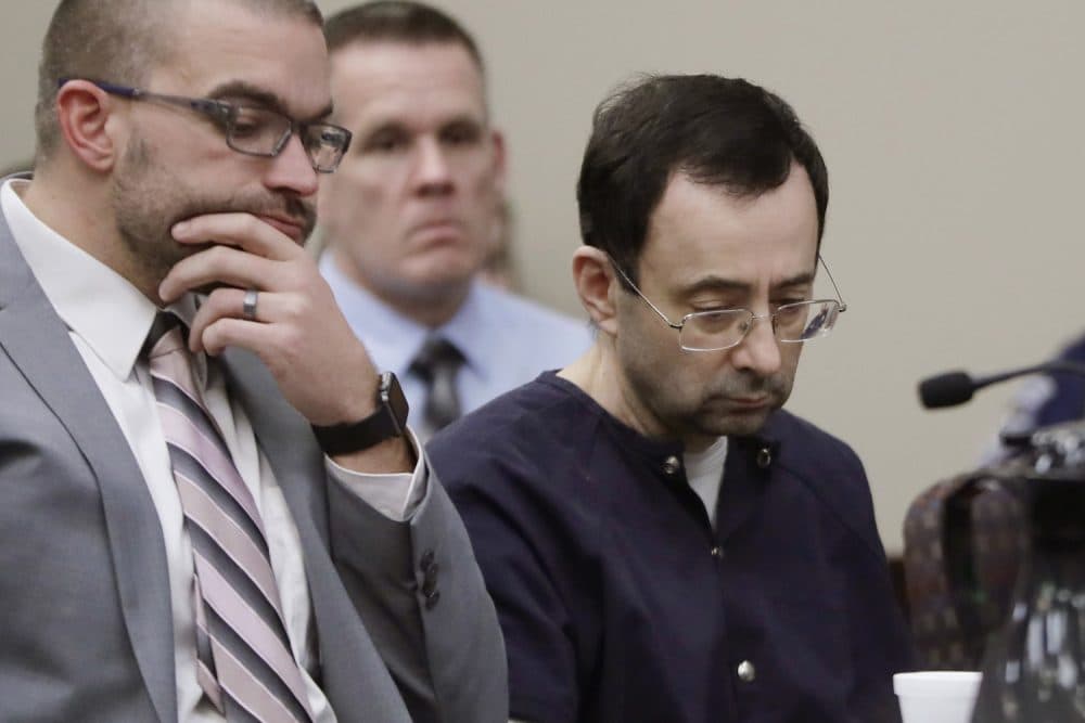 Larry Nassar sits with attorney Matt Newburg during his sentencing hearing Wednesday, Jan. 24, 2018, in Lansing, Mich. The former sports doctor who admitted molesting some of the nation's top gymnasts for years was sentenced Wednesday to 40 to 175 years in prison as the judge declared: "I just signed your death warrant."  The sentence capped a remarkable seven-day hearing in which scores of Nassar's victims were able to confront him face to face in the Michigan courtroom.  (AP Photo/Carlos Osorio)