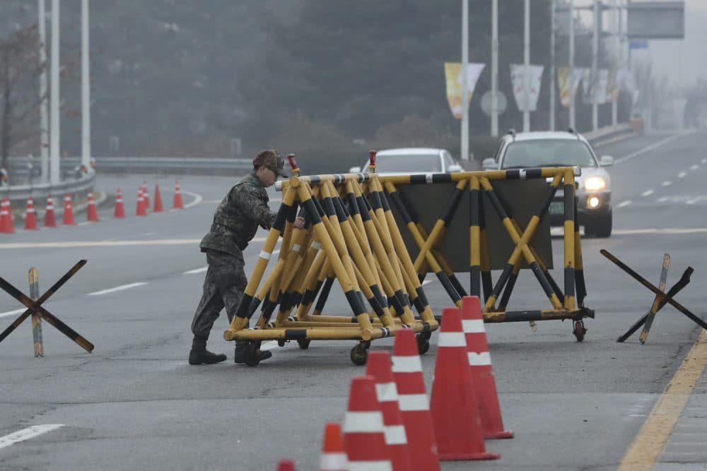 A South Korean soldier adjusts barricade before South Korea's delegation vehicle's arriving at Unification Bridge, which leads to the Panmunjom in the Demilitarized Zone in Paju, South Korea, Monday, Jan. 15, 2018. Officials from the two Koreas met Monday to work out details about North Koreas plan to send an art troupe to the South during next months Winter Olympics, as the rivals tried to follow up on the Norths recent agreement to cooperate in the Games in a conciliatory gesture following months of nuclear tensions. (AP Photo/Lee Jin-man)