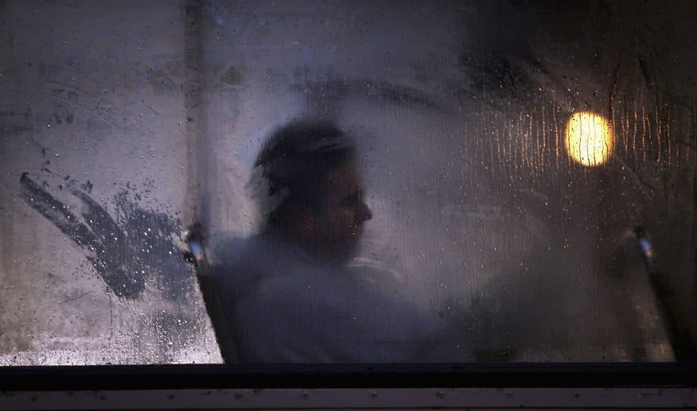 A man makes his way home from work on a bus as darkness falls in Glasgow, Scotland. (Christopher Furlong/Getty Images)