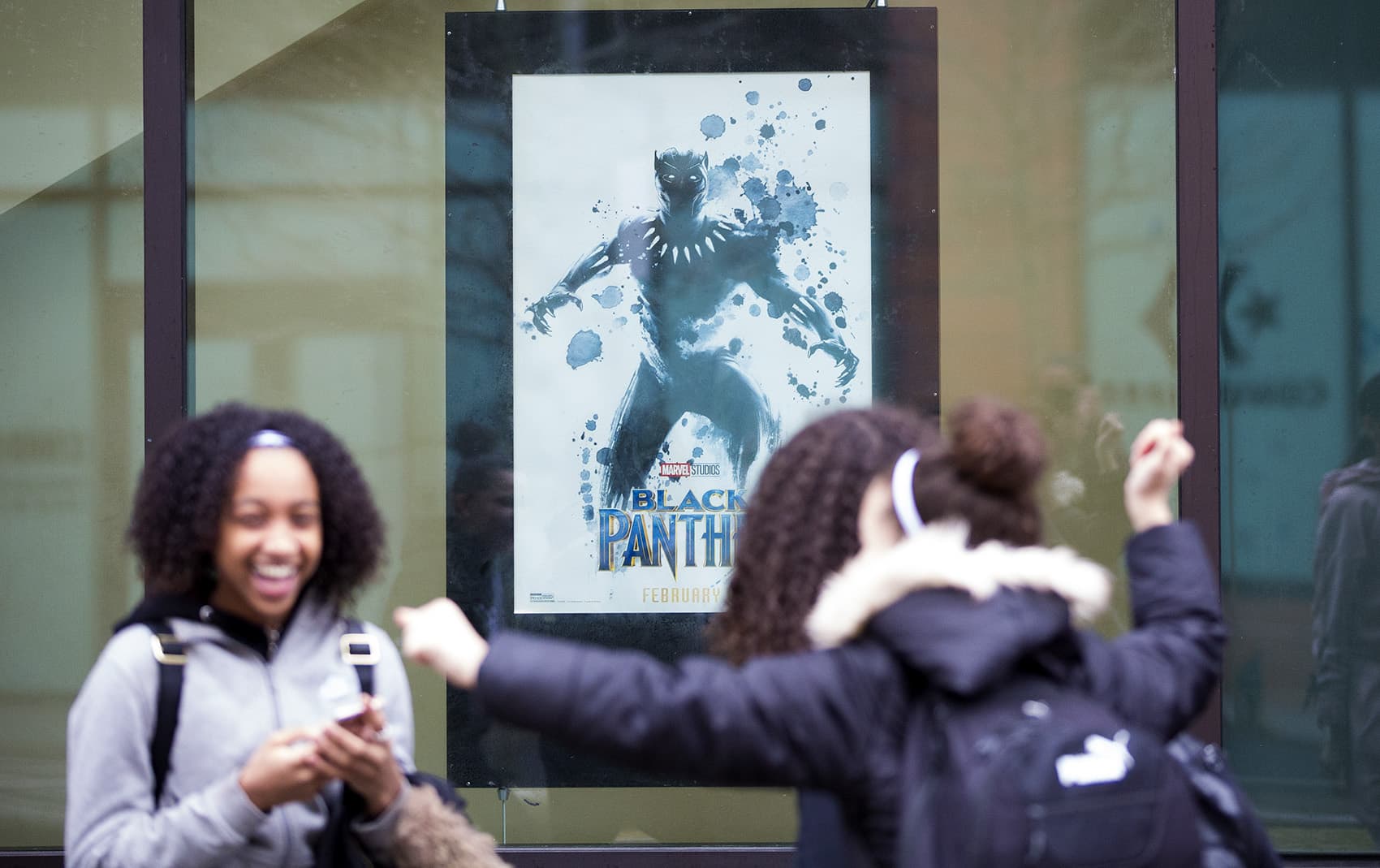 Students from the New Mission High School in Hyde Park line up to attend a private screening of "Black Panther" at the South Bay AMC Theater. (Jesse Costa/WBUR)