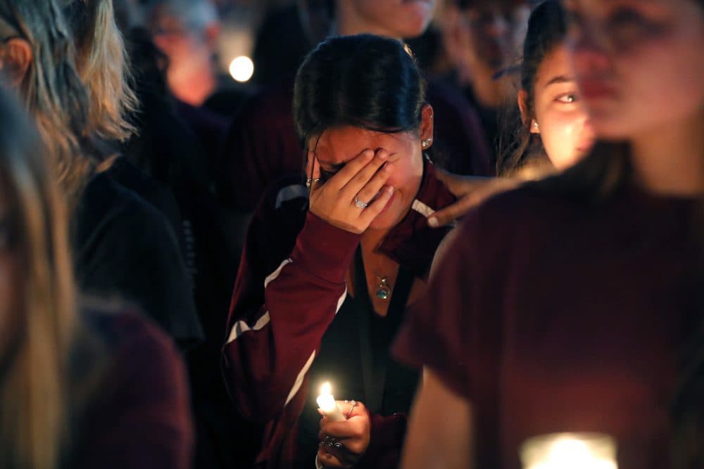 A woman cries during a candlelight vigil for the victims of the Wednesday shooting at Marjory Stoneman Douglas High School, in Parkland, Fla., Thursday, Feb. 15, 2018. (Gerald Herbert/AP)