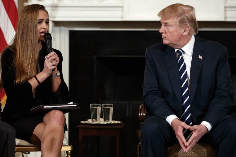 President Donald Trump, looks to Julia Cordover, the student body president at Marjory Stoneman Douglas High School in Parkland, Fla., as she speaks during the listening session with high school students, teachers, and others in the State Dining Room of the White House in Washington, Wednesday, Feb. 21, 2018. (AP Photo/Carolyn Kaster)