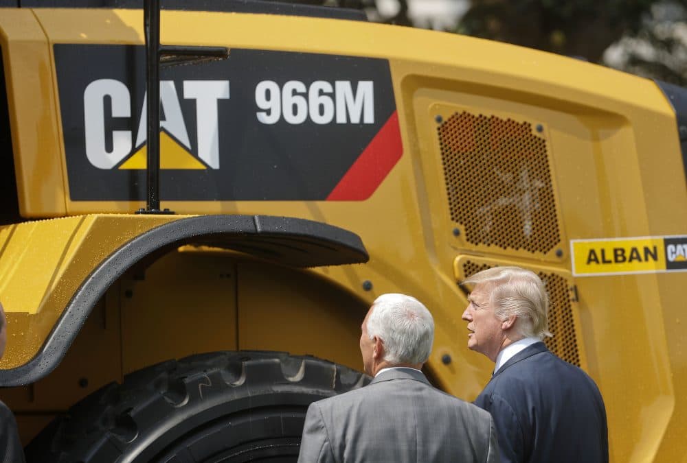 President Trump and Vice President Mike Pence stop to looks at a Caterpillar truck, manufactured in Illinois, on the South Lawn of the White House in Washington, Monday, July 17, 2017, during a "Made in America," product showcase featuring items created in each of the U.S. 50 states. (Pablo Martinez Monsivais/AP)