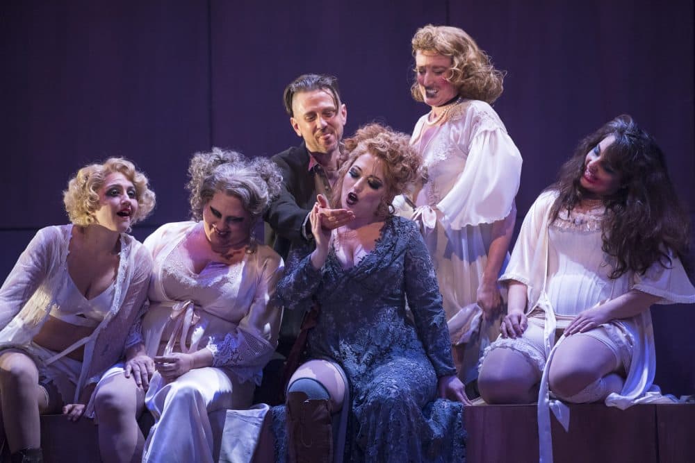 Jenny (Renee Tatum, in blue) reads the palm of Macheath (Christopher Burchett, center, top) in BLO's "The Threepenny Opera." (Courtesy Liza Voll Photography)