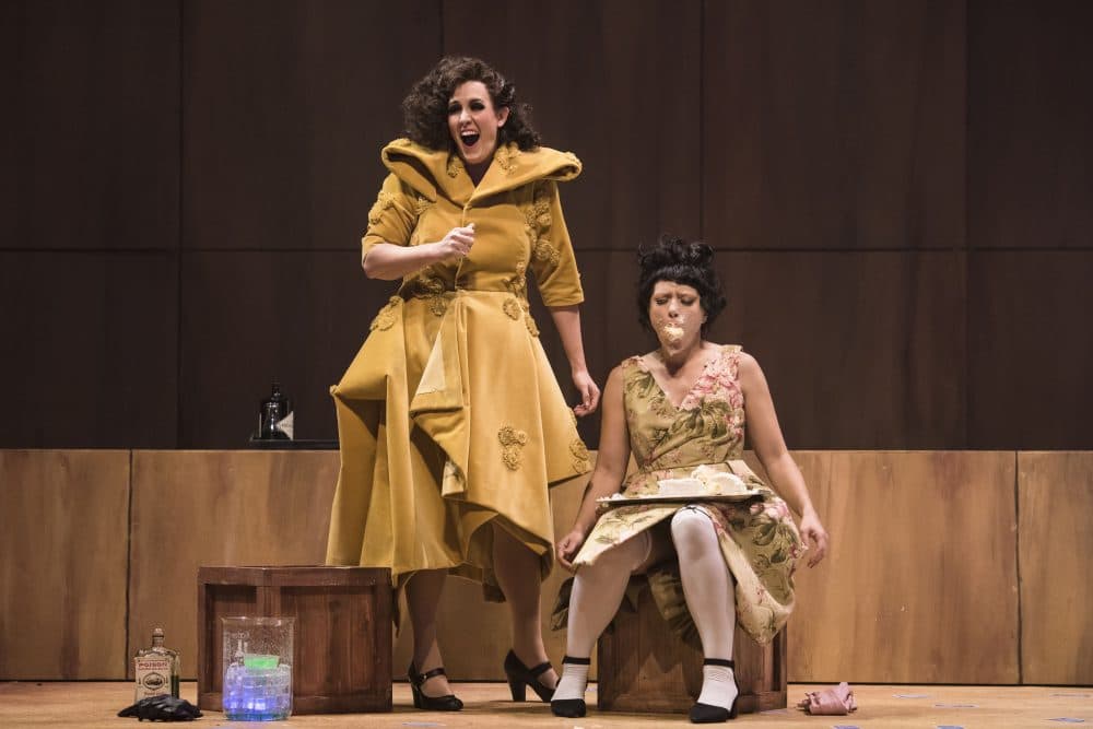 Lucy (Chelsea Basler, left) silences Polly Peachum (Kelly Kaduce), her rival for Macheath's affections, with a piece of cake in the BLO's "The Threepenny Opera." (Courtesy Liza Voll Photography)