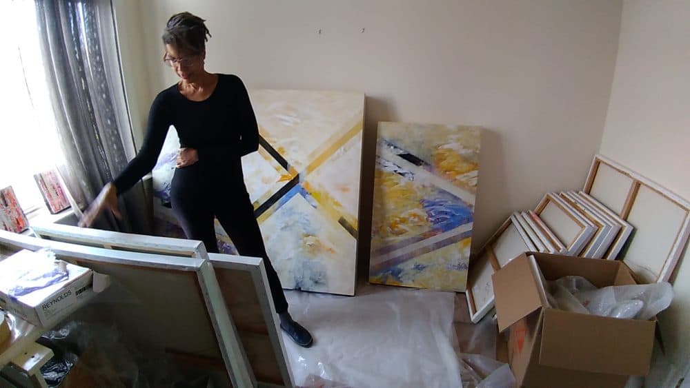 Artist Pamela Reynolds sorts through her paintings. (Courtesy)