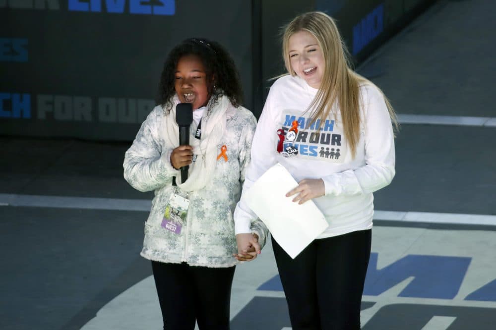 Yolanda Renee King, grand daughter of Martin Luther King Jr., left, speaks as Jaclyn Corin, a student at Marjory Stoneman Douglas High School in Parkland, Fla., and one of the organizers of the rally, holds hands with her during the "March for Our Lives" rally in support of gun control, Saturday, March 24, 2018, in Washington. (Alex Brandon/AP)