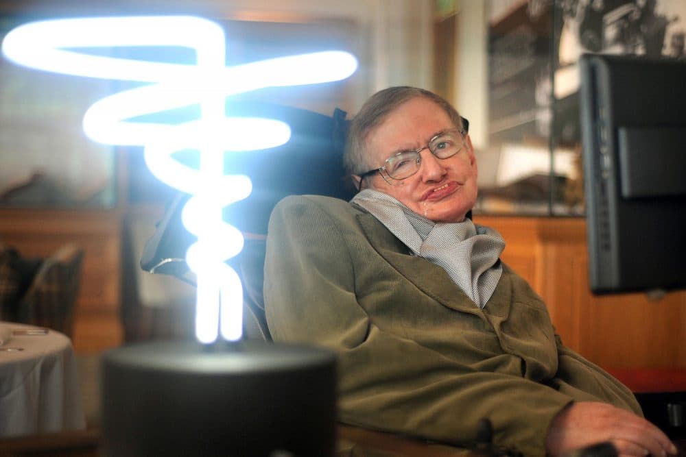 In this Feb. 25, 2012 photo, Professor Stephen Hawking poses beside a lamp titled 'black hole light' by inventor Mark Champkins, presented to him during his visit to the Science Museum in London. Hawking, whose brilliant mind ranged across time and space though his body was paralyzed by disease, died early Wednesday, March 18, 2018, a University of Cambridge spokesman said. He was 76. (Anthony Devlin/PA via AP)