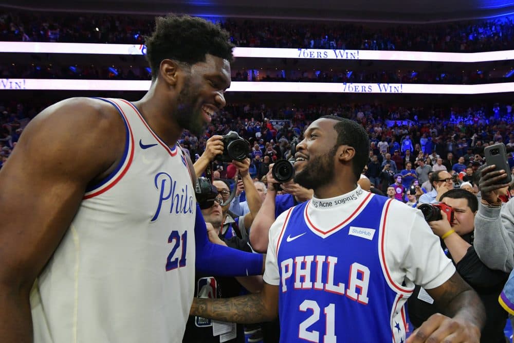 Joel Embiid celebrates with Meek Mill after the 76ers clinched their first round series against the Miami Heat. (Drew Hallowell/Getty Images)